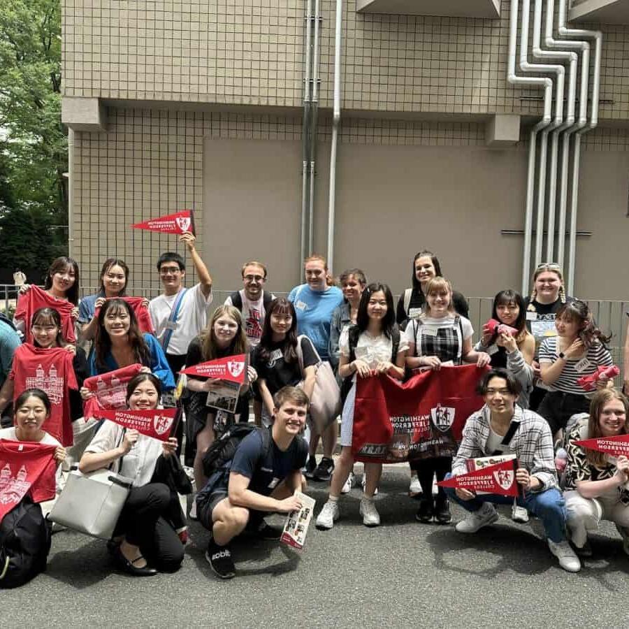 Students and faculty pose with W&J flags in Japan.